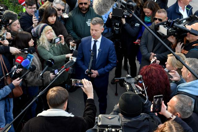 Peter Magyar (C), leader of the pro-European conservative TISZA party, talks with journalists outside a polling station in Budapest during a general election in Hungary, on April 12, 2026. The vote could end Hungarian Prime Minister Viktor Orban's 16-year stint in power as the EU's longest serving current leader and a self-decribed "thorn" in the bloc's side. (Photo by Ferenc ISZA / AFP)