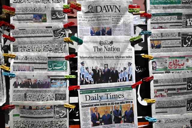 English and Urdu newspapers are displayed at a roadside stall after US-Iran peace talks in Islamabad on April 12, 2026. Iran and the United States failed to reach an agreement to end the war in the Middle East, US Vice President JD Vance said on April 12 after marathon talks in Islamabad, adding that he was leaving negotiations after giving Tehran the "final and best offer". (Photo by Aamir QURESHI / AFP)