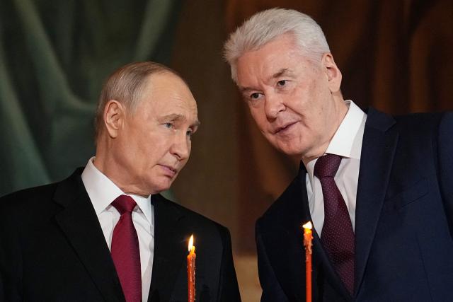 Russia's President Vladimir Putin (L) and Moscow Mayor Sergey Sobyanin (R) attend the Orthodox Easter service at the Cathedral of Christ the Saviour in Moscow on April 12, 2026. (Photo by Alexander Zemlianichenko / POOL / AFP)