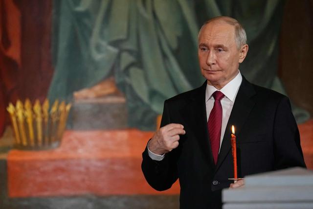 Russia's President Vladimir Putin makes the sign of the cross during the Orthodox Easter service at the Cathedral of Christ the Saviour in Moscow on April 12, 2026. (Photo by Alexander Zemlianichenko / POOL / AFP)