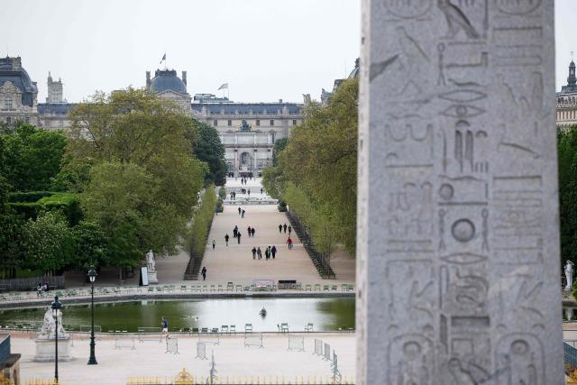This photograph shows the Jardin des Tuileries gardens with the Arc de Triomphe du Carrousel and the Musee du Louvre in the background, and the Obelisque de Louxor (Luxor Obelisk) of Place de la Concorde in the foreground, in Paris on April 12, 2026. (Photo by Ian LANGSDON / AFP)