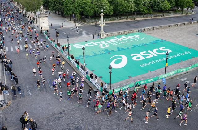 Participants run during the Paris Marathon, in Paris, on April 12, 2026. (Photo by Ian LANGSDON / AFP)