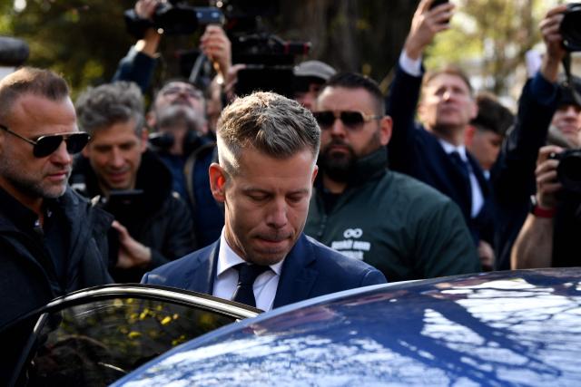 Peter Magyar (C), leader of the pro-European conservative TISZA party, enters his car as he leaves after casting his ballot at a polling station in Budapest during a general election in Hungary, on April 12, 2026. The vote could end Hungarian Prime Minister Viktor Orban's 16-year stint in power as the EU's longest serving current leader and a self-decribed "thorn" in the bloc's side. (Photo by Ferenc ISZA / AFP)