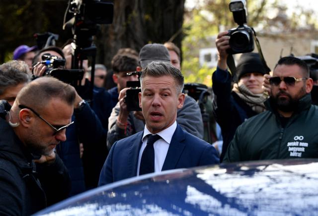 Peter Magyar (C), leader of the pro-European conservative TISZA party, enters his car as he leaves after casting his ballot at a polling station in Budapest during a general election in Hungary, on April 12, 2026. The vote could end Hungarian Prime Minister Viktor Orban's 16-year stint in power as the EU's longest serving current leader and a self-decribed "thorn" in the bloc's side. (Photo by Ferenc ISZA / AFP)