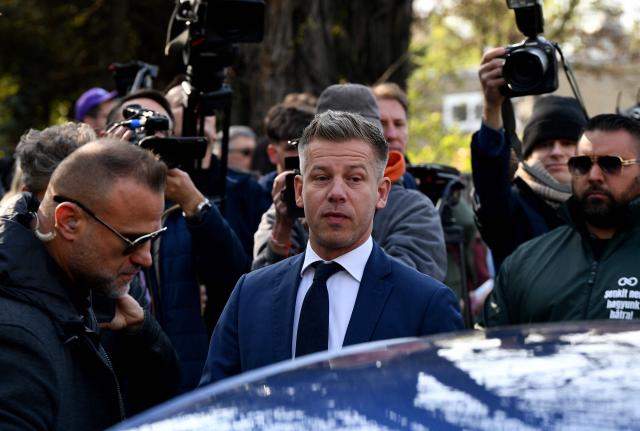 Peter Magyar (C), leader of the pro-European conservative TISZA party, enters his car as he leaves after casting his ballot at a polling station in Budapest during a general election in Hungary, on April 12, 2026. The vote could end Hungarian Prime Minister Viktor Orban's 16-year stint in power as the EU's longest serving current leader and a self-decribed "thorn" in the bloc's side. (Photo by Ferenc ISZA / AFP)