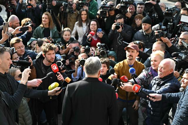 Hungarian Prime Minister Viktor Orban (C) answers journalists' questions after he voted at a polling station set up in a school of the 12th district in Budapest during a general election in Hungary, on April 12, 2026. The vote could end Hungarian Prime Minister Viktor Orban's 16-year stint in power as the EU's longest serving current leader and a self-decribed "thorn" in the bloc's side. (Photo by Attila KISBENEDEK / AFP)