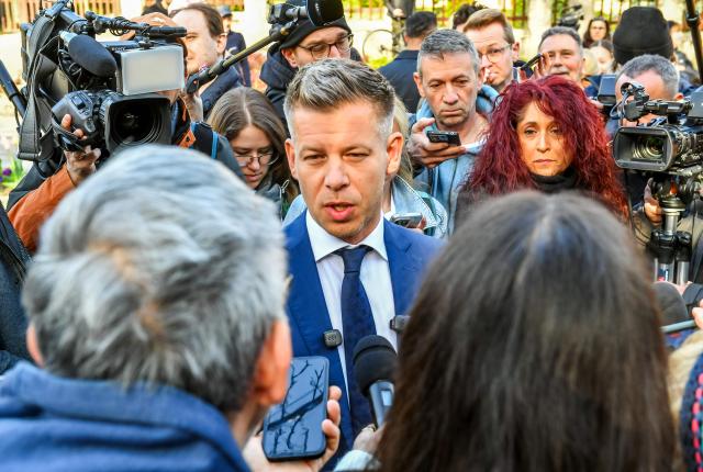 Peter Magyar (C), leader of the pro-European conservative TISZA party, talks with journalists after casting his ballot at a polling station in Budapest during a general election in Hungary, on April 12, 2026. The vote could end Hungarian Prime Minister Viktor Orban's 16-year stint in power as the EU's longest serving current leader and a self-decribed "thorn" in the bloc's side. (Photo by Ferenc ISZA / AFP)