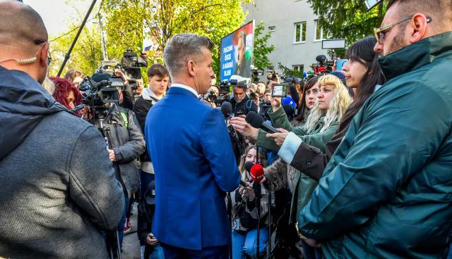 Peter Magyar (C), leader of the pro-European conservative TISZA party, talks with journalists after casting his ballot at a polling station in Budapest during a general election in Hungary, on April 12, 2026. The vote could end Hungarian Prime Minister Viktor Orban's 16-year stint in power as the EU's longest serving current leader and a self-decribed "thorn" in the bloc's side. (Photo by Ferenc ISZA / AFP)