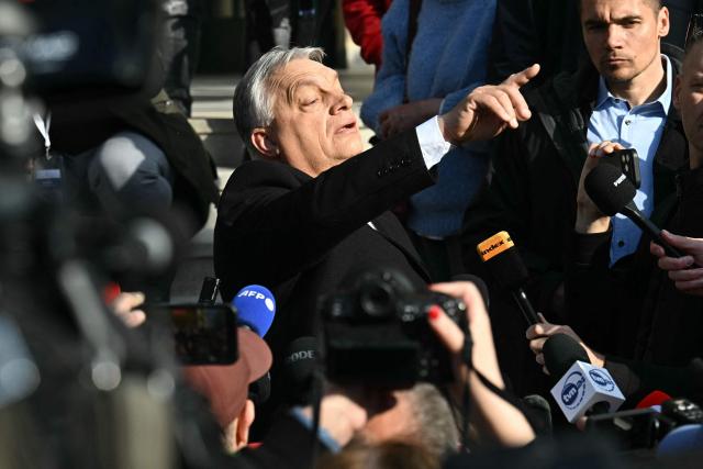 Hungarian Prime Minister Viktor Orban answers journalists' questions after he voted at a polling station set up in a school of the 12th district in Budapest during a general election in Hungary, on April 12, 2026. The vote could end Hungarian Prime Minister Viktor Orban's 16-year stint in power as the EU's longest serving current leader and a self-decribed "thorn" in the bloc's side. (Photo by Attila KISBENEDEK / AFP)