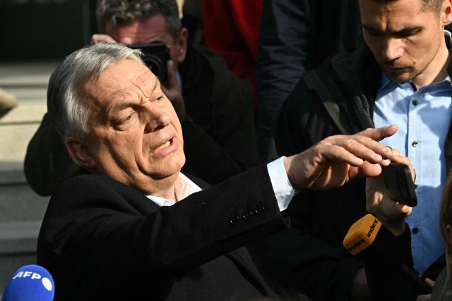 Hungarian Prime Minister Viktor Orban talks with journalists after he voted at a polling station set up in a school of the 12th district in Budapest during a general election in Hungary, on April 12, 2026. The vote could end Hungarian Prime Minister Viktor Orban's 16-year stint in power as the EU's longest serving current leader and a self-decribed "thorn" in the bloc's side. (Photo by Attila KISBENEDEK / AFP)