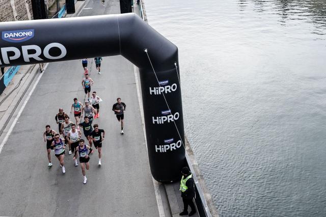 Participants run along the docks of the Seine river during the Paris Marathon, in Paris, on April 12, 2026. (Photo by STEPHANE DE SAKUTIN / AFP)