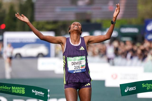 Ethiopia's Shure Demise celebrates as she crosses the finish line to win the women's Paris Marathon, in Paris, on April 12, 2026. (Photo by Ian LANGSDON / AFP)