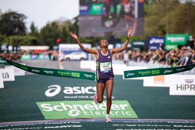 Ethiopia's Shure Demise celebrates as she crosses the finish line to win the women's Paris Marathon, in Paris, on April 12, 2026. (Photo by Ian LANGSDON / AFP)