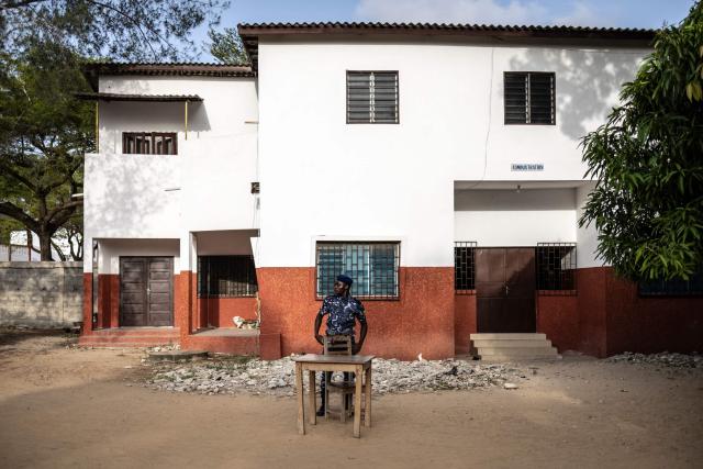 A Benin Police officer stands at a primary school serving as a polling station in Cotonou, on April 12, 2026 during Benin's presidential election. (Photo by OLYMPIA DE MAISMONT / AFP)