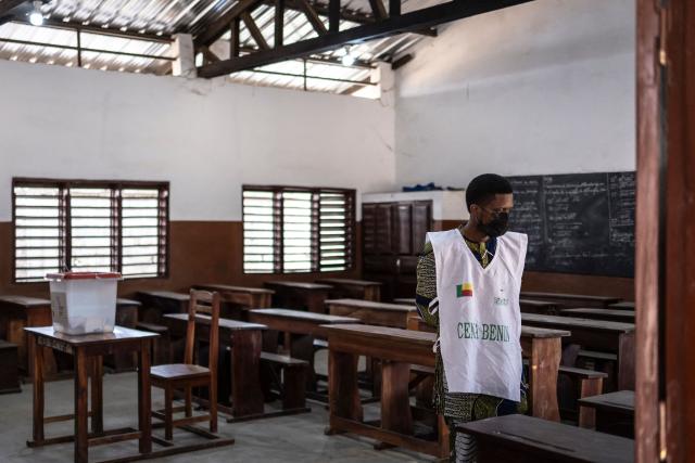 An electoral official waits for voters at a primary school serving as a polling station in Cotonou, on April 12, 2026 during Benin's presidential election. (Photo by OLYMPIA DE MAISMONT / AFP)