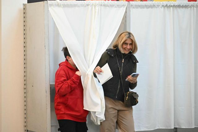 A Hungarian citizen votes at a polling station located in a school of the 12th district in Budapest on April 12, 2026. The vote could end Hungarian Prime Minister Viktor Orban's 16-year stint in power as the EU's longest serving current leader and a self-decribed "thorn" in the bloc's side. (Photo by Attila KISBENEDEK / AFP)