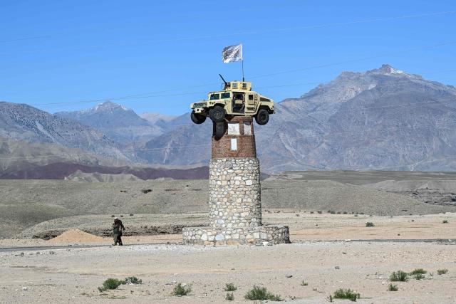 A former US military Humvee with the Taliban flag flying over it is displayed atop a tower in the Naghlu area of Surobi district, Kabul province, on April 12, 2026. (Photo by Wakil KOHSAR / AFP)