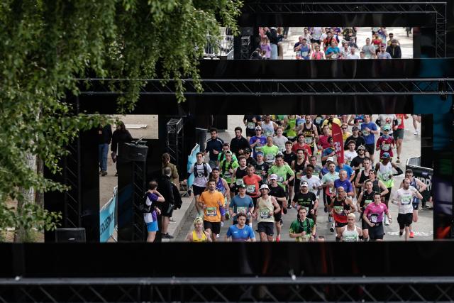 Participants run along the docks of the Seine river during the Paris Marathon, in Paris, on April 12, 2026. (Photo by STEPHANE DE SAKUTIN / AFP)