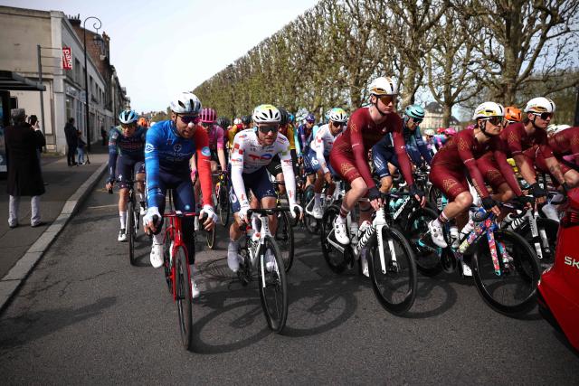 The pack rides to the real start of the 123rd edition of the Paris-Roubaix one-day classic cycling race, 258.3 km between Compiègne and Roubaix, northern France, on April 12, 2026. (Photo by Anne-Christine POUJOULAT / AFP)