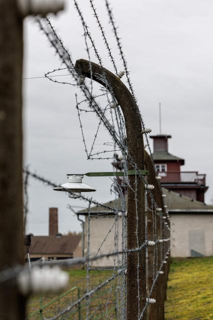 A barbed wire fence encloses the memorial site of the former Nazi concentration camp Buchenwald on April 12, 2026, prior to the commemoration ceremony to mark the 81th anniversary of the liberation of the Buchenwald Nazi concentration camp at the camp's memorial site near Weimar, eastern Germany. From 1937 to 1945, almost 280,000 victims of the Nazis were imprisoned in Buchenwald concentration camp and its satellite camps; more than 56,000 were murdered or died as a result of inhumane conditions. Among the prisoners were Jews, Roma, domestic political opponents of the Nazis, and forced laborers from Eastern Europe. Buchenwald is one of the most symbolically significant and best-known former concentration camps in Germany. (Photo by JENS SCHLUETER / AFP)