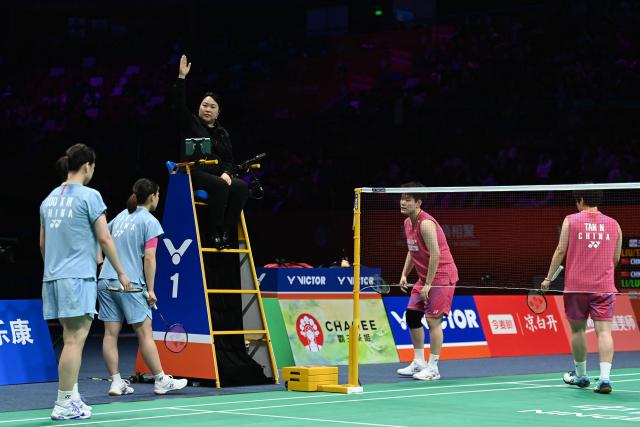 Liu Shengshu (2/R) and Tan Ning (R) of China retire due to injury in their women's doubles final match against Li Yijing (2/L) and Luo Xumin (L) of China at the Badminton Asia Championship in Ningbo, in China's eastern Zhejiang province, on April 12, 2026. (Photo by CN-STR / AFP) / China OUT
