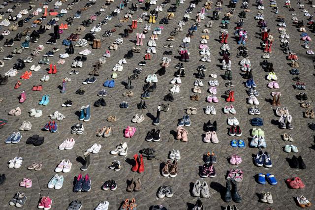 A photo shows children's shoes layed out on Dam Square during a memorial protest organised by Plant an Olive Tree group for child victims in Gaza, in Amsterdam, on April 12, 2026. (Photo by Ramon van Flymen / ANP / AFP) / Netherlands OUT