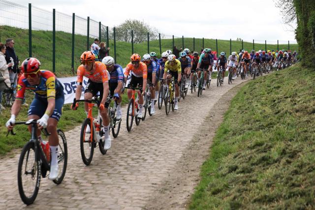 The pack rides on the first cobblestone sector of "Troisville" during the 123rd edition of the Paris-Roubaix one-day classic cycling race, 258.3 km between Compiègne and Roubaix, northern France, on April 12, 2026. (Photo by Francois LO PRESTI / AFP)