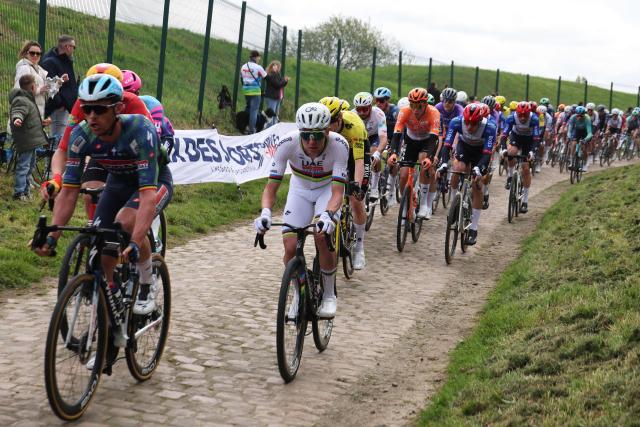 UAE Team Emirates XRG's Slovenian rider Tadej Pogacar rides with the pack on the first cobblestone sector of "Troisville" during the 123rd edition of the Paris-Roubaix one-day classic cycling race, 258.3 km between Compiègne and Roubaix, northern France, on April 12, 2026. (Photo by Francois LO PRESTI / AFP)