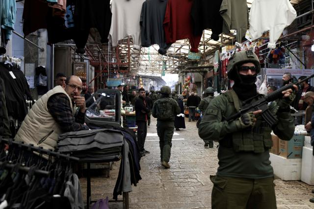 Israeli soldiers patrol through the market in the Old City of Nablus, in the northern Israeli-occupied Palestinian West Bank on April 12, 2026. Israeli police said on April 12, eight suspects were arrested after an overnight attack by Israeli civilians on a Palestinian village in the occupied West Bank. Violence in the West Bank, which Israel has occupied since 1967, has risen sharply since the October 7, 2023 Hamas attack on Israel triggered the Gaza war. (Photo by JAAFAR ASHTIYEH / AFP)