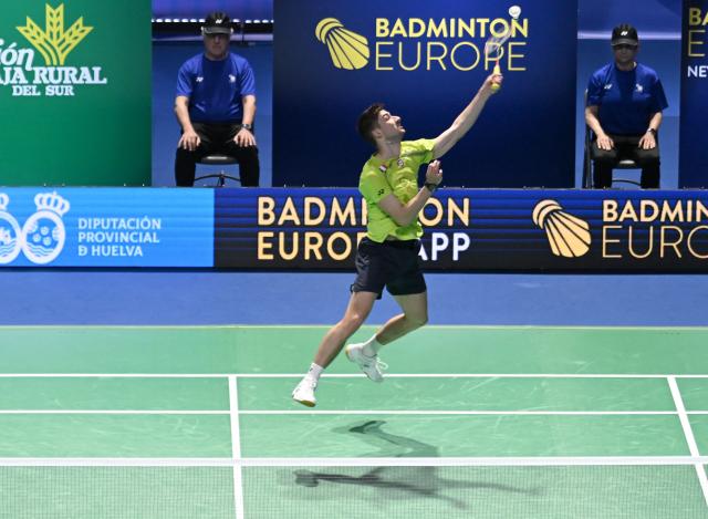 France’s Christo Popov hits a return to Denmark’s Anders Antonsen during their men’s singles semifinal match of the Badminton European Championships' finale at the Carolina Marin Sports Palace in Huelva on April 12, 2026. (Photo by Cristina Quicler / AFP)