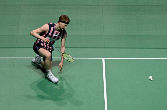 Denmark’s Anders Antonsen reacts during his men’s singles semifinal match against France’s Christo Popov of the Badminton European Championships' finale at the Carolina Marin Sports Palace in Huelva on April 12, 2026. (Photo by Cristina Quicler / AFP)