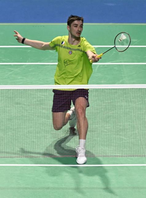 France’s Christo Popov hits a return to Denmark’s Anders Antonsen during their men’s singles semifinal match of the Badminton European Championships' finale at the Carolina Marin Sports Palace in Huelva on April 12, 2026. (Photo by Cristina Quicler / AFP)