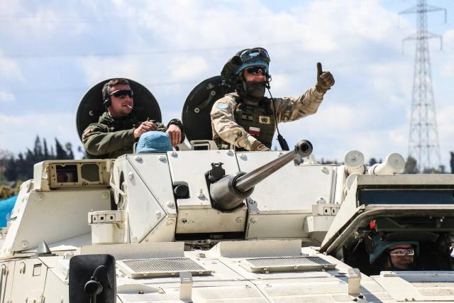 Members of the UN peacekeeping force in Lebanon (UNIFIL), in armored vehicles, patrol the road of the southern Lebanese village of Tair Debba on April 12, 2026. Dozens of countries contributing troops to the UN peacekeeping force in Lebanon called on April 9, 2026, for a cessation of hostilities, after three blue helmets were killed as Israel and Hezbollah traded strikes. (Photo by Kawnat HAJU / AFP)