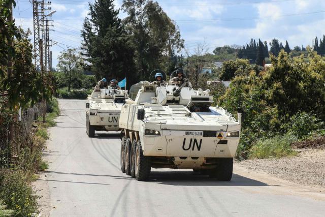Members of the UN peacekeeping force in Lebanon (UNIFIL), in armored vehicles, patrol the road of the southern Lebanese village of Tair Debba on April 12, 2026. Dozens of countries contributing troops to the UN peacekeeping force in Lebanon called on April 9, 2026, for a cessation of hostilities, after three blue helmets were killed as Israel and Hezbollah traded strikes. (Photo by Kawnat HAJU / AFP)