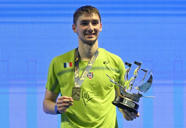 France’s Christo Popov holds his trophy after winning Denmark’s Anders Antonsen in their men’s singles final match of the Badminton European Championships' finale at the Carolina Marin Sports Palace in Huelva on April 12, 2026. (Photo by Cristina Quicler / AFP)