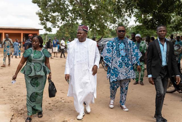 Presidential candidate Paul Hounkpe (2nd L) arrives to cast his ballot at a polling station in Lobogo on April 12, 2026 during Benin's presidential election. (Photo by Yanick Folly / AFP)