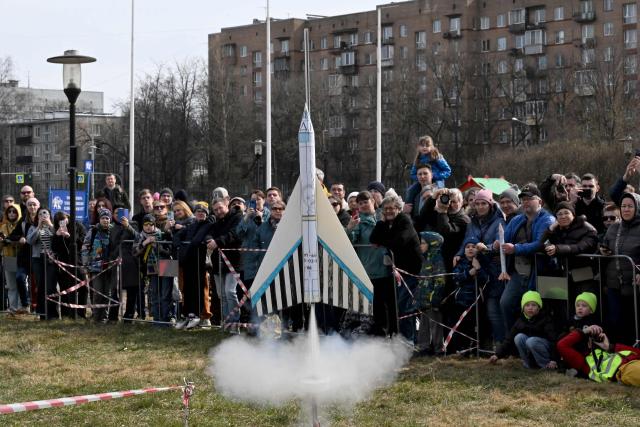 Attendees watch the launch of a model rocket during celebrations marking the 65th anniversary of Russia's Yuri Gagarin's first manned flight into space in Saint Petersburg on April, 12, 2026. (Photo by Olga MALTSEVA / AFP)
