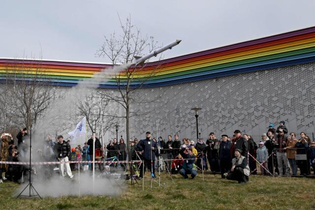 Attendees watch the launch of a model rocket during celebrations marking the 65th anniversary of Russia's Yuri Gagarin's first manned flight into space in Saint Petersburg on April, 12, 2026. (Photo by Olga MALTSEVA / AFP)