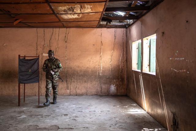 A Benin soldier leaves a voting booth before casting his ballot at a primary school serving as a polling station in Cotonou, on April 12, 2026 during Benin's presidential election. (Photo by OLYMPIA DE MAISMONT / AFP)
