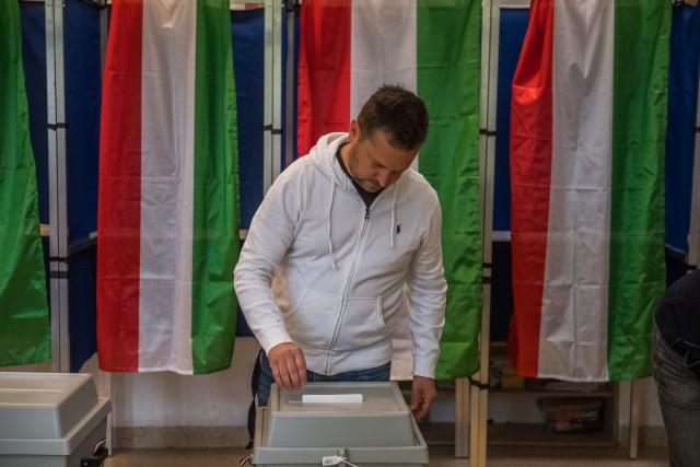 A man casts his ballot at a polling station in Solymar, 20kms far from Budapest at the general election in Hungary, on April 12, 2026. Turnout in Hungary's closely watched parliamentary polls hit a record 54 percent at midday, election authorities said, as voters flocked to participate in a ballot that could end nationalist Prime Minister Viktor Orban's 16-year rule. (Photo by Ferenc ISZA / AFP)