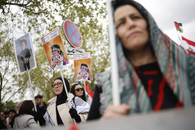 A person holds a placard reading "No to the Yadan bill" as protesters take part in a rally against the Yadan bill, which aims to combat new forms of anti-Semitism, in Paris on April 12, 2026. The proposed bill, named after French lawmaker from the presidential camp Caroline Yadan and will be debated next April 16 and 17, aims to combat "new forms" of anti-Semitism and has met with strong reservations. Its opponents, particularly on the left, argue that it would threaten freedom of expression and perpetuate a conflation of Jews and Israel. (Photo by Ian LANGSDON / AFP)