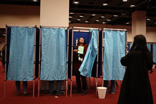 Voters use the polling booths as they vote in the Hungarian election inside the polling station set up at a hotel in west London, on April 12, 2026. The vote could end Hungarian Prime Minister Viktor Orban's 16-year stint in power as the EU's longest serving current leader and a self-decribed "thorn" in the bloc's side. (Photo by Henry Nicholls / AFP)