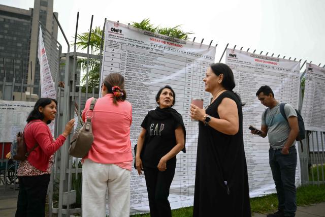 People wait in line outside a polling station in Lima on April 12, 2026 during general elections. Peruvians will elect a new president from a record field of 35 candidates to lead a country plagued by organized crime and chronic political instability. (Photo by Luis ROBAYO / AFP)