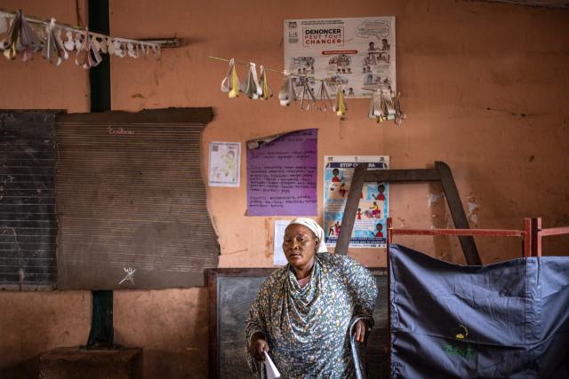 A voter leaves a voting booth before casting her ballot at a primary school serving as a polling station in Cotonou, on April 12, 2026 during Benin's presidential election. (Photo by OLYMPIA DE MAISMONT / AFP)
