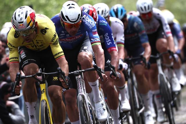 Team Visma - Lease a Bike's Belgian rider Wout van Aert leads ahead of Alpecin-Premier Tech's Dutch rider Mathieu van der Poel as they cycle on the 'Trouйe d’Arenberg' cobblestone sector (Arenberg trench) during the 123rd edition of the Paris-Roubaix one-day classic cycling race, 258.3 km between Compiиgne and Roubaix, northern France, on April 12, 2026. (Photo by Anne-Christine POUJOULAT / AFP)