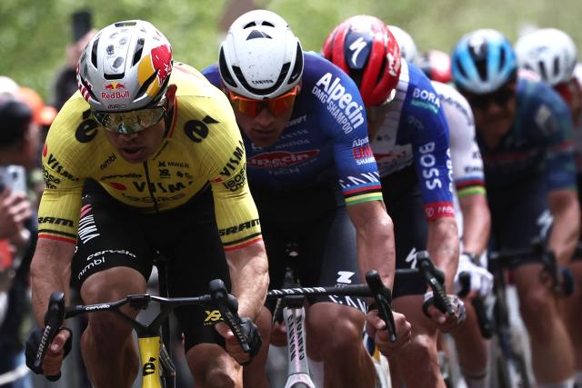Team Visma - Lease a Bike's Belgian rider Wout van Aert leads ahead of Alpecin-Premier Tech's Dutch rider Mathieu van der Poel as they cycle on the 'Trouйe d’Arenberg' cobblestone sector (Arenberg trench) during the 123rd edition of the Paris-Roubaix one-day classic cycling race, 258.3 km between Compiиgne and Roubaix, northern France, on April 12, 2026. (Photo by Anne-Christine POUJOULAT / AFP)