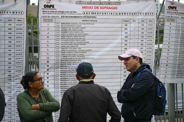 People wait to vote outside a polling station in Lima on April 12, 2026, during general elections. Peruvians will elect a new president from a record field of 35 candidates to lead a country plagued by organized crime and chronic political instability. (Photo by Luis ROBAYO / AFP)