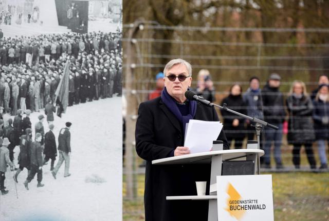 German comedian and actor Hape Kerkeling, grandson of former Buchenwald camp prisoner Hermann Anton Kerkeling, gives a speech during the commemoration ceremony to mark the 81th anniversary of the liberation of the Buchenwald Nazi concentration camp at the camp's memorial site near Weimar, eastern Germany, on April 12, 2026. From 1937 to 1945, almost 280,000 victims of the Nazis were imprisoned in Buchenwald concentration camp and its satellite camps; more than 56,000 were murdered or died as a result of inhumane conditions. Among the prisoners were Jews, Roma, domestic political opponents of the Nazis, and forced laborers from Eastern Europe. Buchenwald is one of the most symbolically significant and best-known former concentration camps in Germany. (Photo by Jens SCHLUETER / AFP)