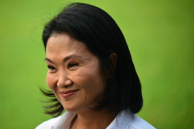 Peru's presidential candidate for the Fuerza Popular party, Keiko Fujimori visits the Campo Fe de Huachipa cemetery, where her father, Peru's former President (1990-200) Alberto Fujimori's remains are buried, in the east of Lima on April 12, 2026, during the presidential election. Peruvians will elect a new president from a record field of 35 candidates to lead a country plagued by organized crime and chronic political instability. (Photo by ERNESTO BENAVIDES / AFP)