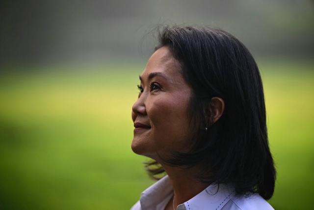 Peru's presidential candidate for the Fuerza Popular party, Keiko Fujimori visits the Campo Fe de Huachipa cemetery, where her father, Peru's former President (1990-200) Alberto Fujimori's remains are buried, in the east of Lima on April 12, 2026, during the presidential election. Peruvians will elect a new president from a record field of 35 candidates to lead a country plagued by organized crime and chronic political instability. (Photo by ERNESTO BENAVIDES / AFP)
